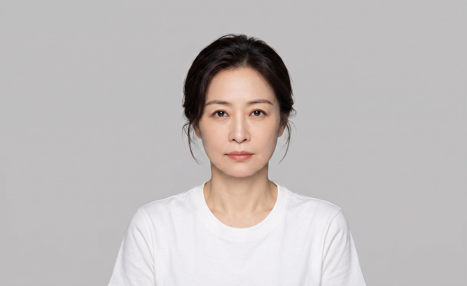 Passport photo after: plain even backdrop, no shadow behind the head