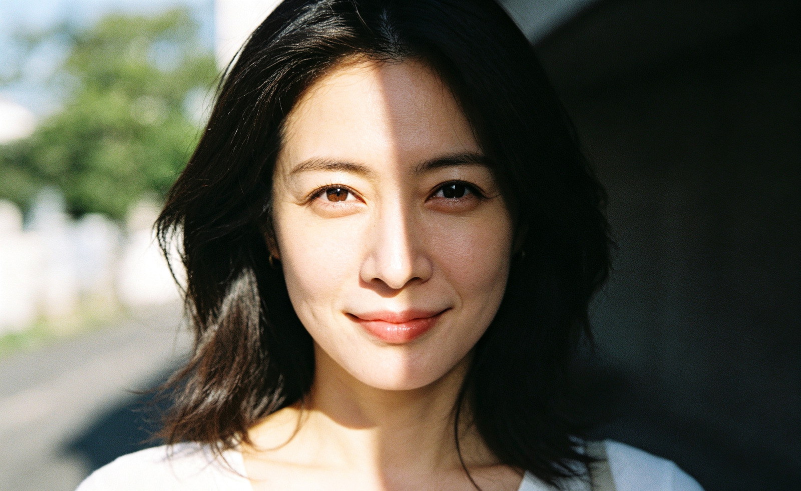 Portrait before: hard window light throws a shadow across half the face
